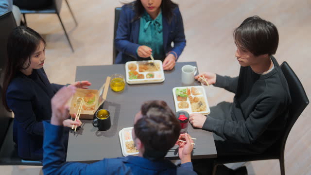 Group of multi-racial business people having lunch together in office