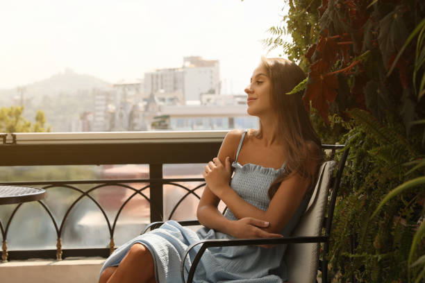 istock Beautiful young woman on balcony. Space for text 1487093124
