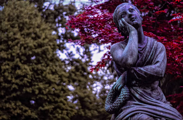 statue of a woman at the Stadtgottesacker - a cemetery in Camposanto style - in Halle in a sepia black and white picture