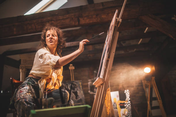 istock young female artist working in her studio 1487095429
