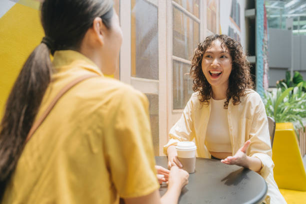 istock Two asian businesspeople having a discussion while walking in the city 1487095444