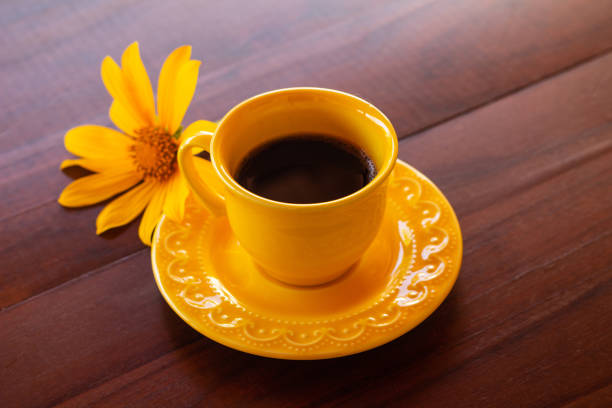 istock A yellow cup with coffee and a sunflower. 1487095605
