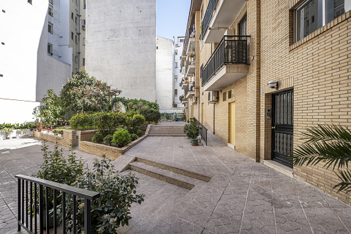 Inner courtyard of common areas of urban residential homes with gardens and decorative plants