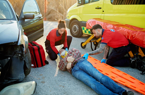 istock Ambulance staff moving accident victim onto spinal board 1487097303