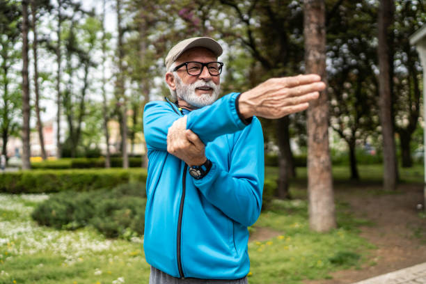 istock Stretching, exercise senior man in park enjoying being active in summer, nature and retirement 1487097951