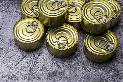 Set of small circular metal storage tins with easy-open tabs