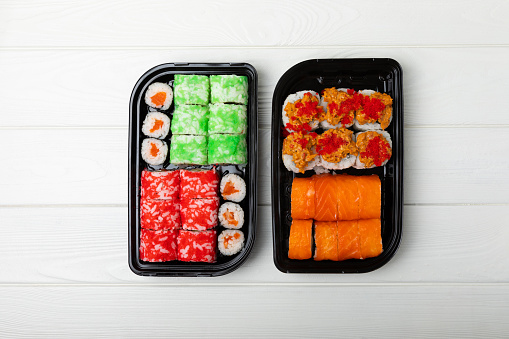 Assorted sushi. Big set of sushi. A variety of Japanese sushi with crab, salmon, eel and caviar on a white wooden table. Top viewCopy space. food delivery