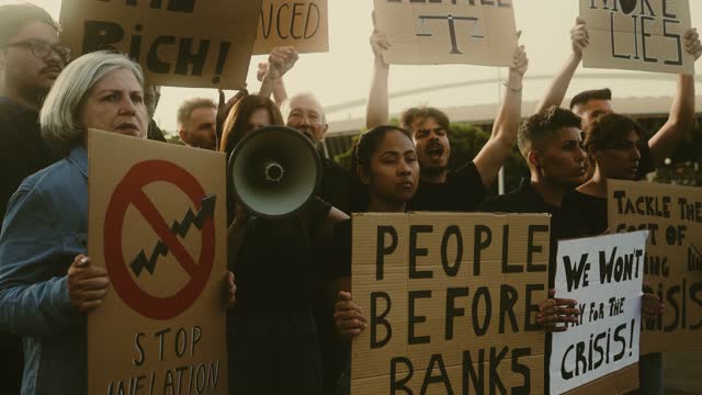 Demonstration of multiracial activists protesting against financial crisis and global inflation - Economic justice activism concept