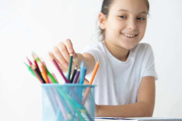 Little girl sitting at the desk.