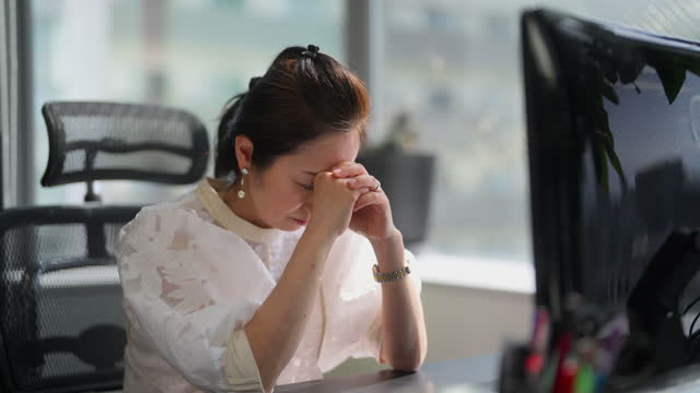 Businesswoman feeling stressed in office