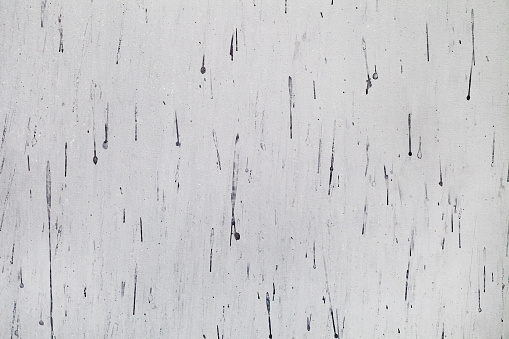 Background painted with gray paint surface with dark drops streaks, uniform texture