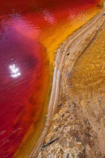 natural Textures of sulfuric deep red Water of Rio Tinto river, Province Huelva, Andalusia, Spain