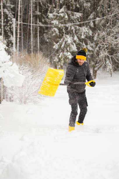 istock Adult man clears the paths from snow with a shovel 1487103329
