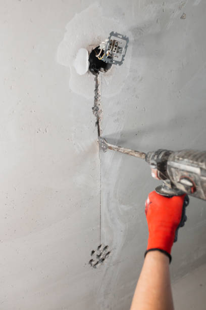 istock Chasing channels in a concrete wall for hidden wiring of communications 1487103502