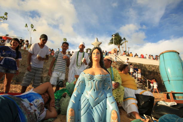 salvador, bahia, brazil - february 2, 2016: Supporters of Orixa Yemanja are seen during Candomble ritual celebration at Rio Vermelho beach in Salvador.