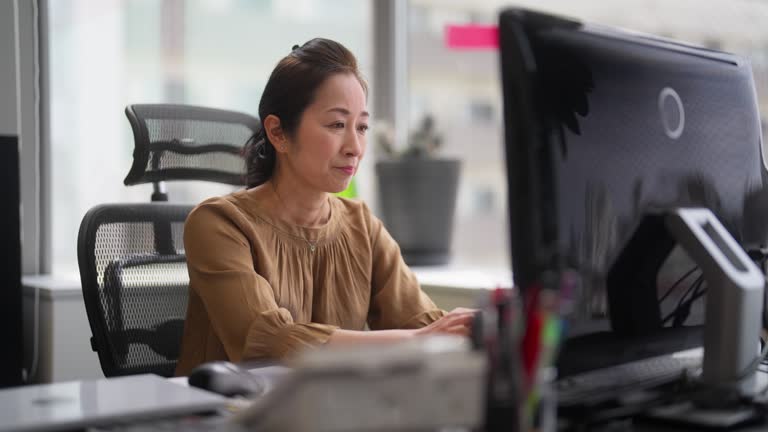 Businesswoman joining business online video conference on computer in office