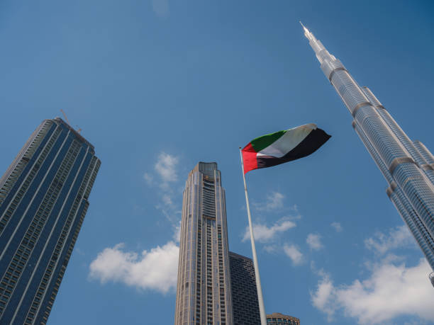 istock United Arab Emirates flag flying against sky. 1487107901