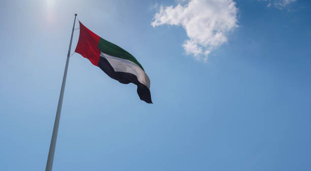 istock United Arab Emirates flag flying against sky. 1487107930