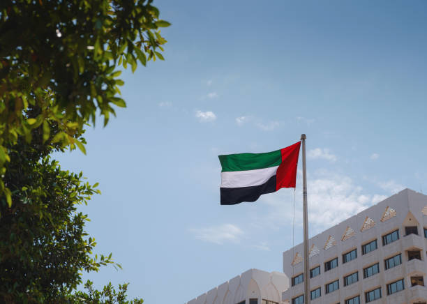 istock United Arab Emirates flag flying against sky. 1487107976