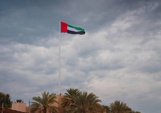 istock United Arab Emirates flag flying against sky. 1487108013