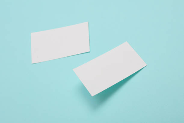 istock White Blank business card for corporate identity on blue background. Creative mockup. 1487111107