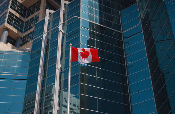 istock Flag of Canada flying against a blue sky. 1487111133