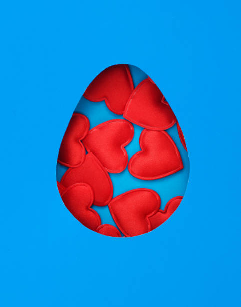 istock Happy easter. Hole blue paper space in the shape of egg and hearts 1487111310