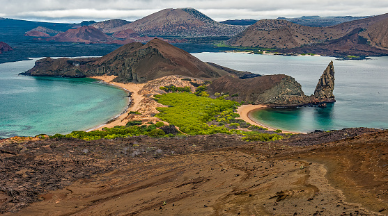 Bartolome Island, the Pinnacle Rock and the Sulivan Bay lava flow on James Island. Galapagos Islands, Ecuador.
