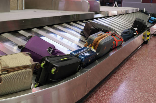 istock Luggage  coming from conveyor belt 1487112304