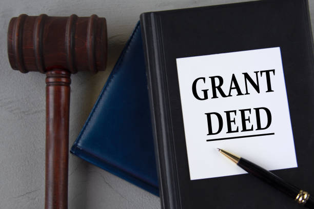 istock GRANT DEED - words on a white sheet with leather notebooks, a judge's hammer and a pen 1487112359