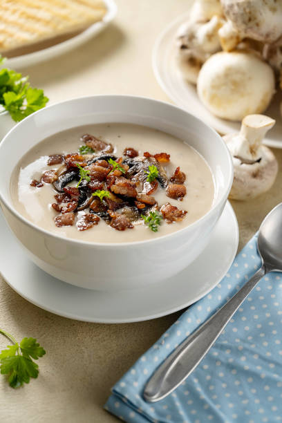 istock Mushroom creamy soup with bakon garnish in a bowl. 1487112613