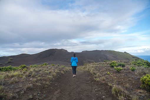 One women walking up the Capelinhos volcano on the island Faial, Azores
