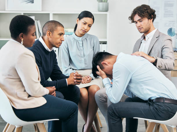 istock Depression, support and unity by colleagues comforting male after getting bad news at work. Community care from workers sitting together, supporting their friend after being fired or through grief 1487115598