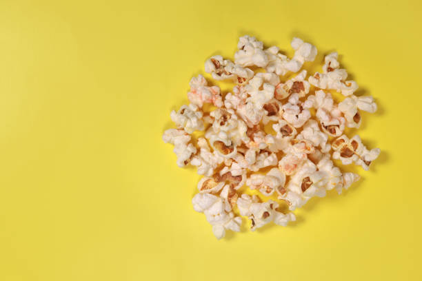 istock popcorn on yellow background, movie snacks. copy space for text 1487117489