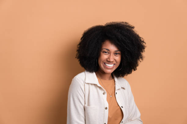 istock woman smiling and standing wearing white jacket 1487119180