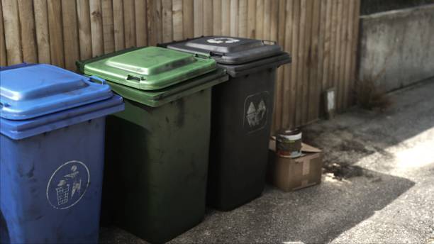 istock Rubbish Bins (Recycling, Garden, General Waste) Lined Up in Street 1487121194