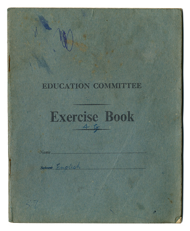 An old exercise book owned by a schoolchild in the mid-20th century; it has been used for English. (All identifying details removed.)
