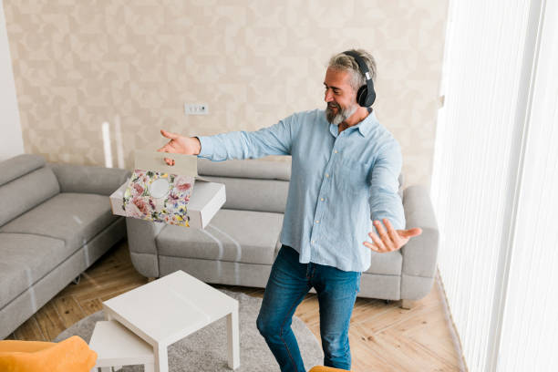 istock Senior man receiving food order and dancing 1487129016