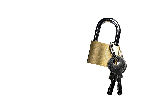 Close up of small brass gold metal steel padlock shackle lock with attached keys on white background as concept for security locker and safety