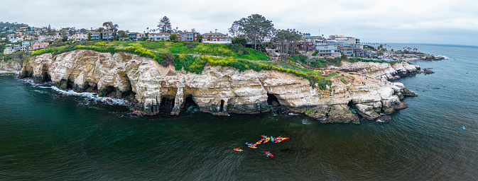 Kayaks explore the La Jolla Ecological Reserve that has thriving ecosystem and has a high concentration of sea life.