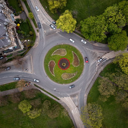 Aerial view directly above a road roundabout in Harrogate, North Yorkshire with landscaped flower beds during the Spring Floral Trail