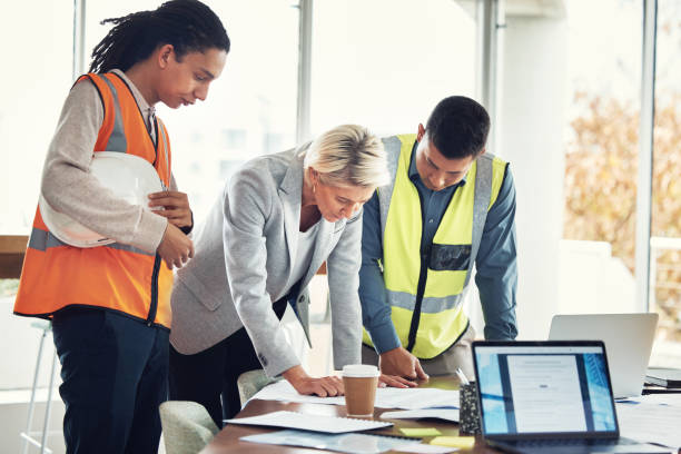 istock Engineering, meeting and blueprint with people in office for construction, designer or building. Collaboration, review and teamwork with group in architecture firm for project management and goal 1487148684