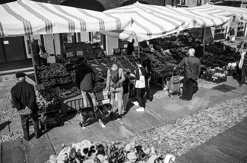 Varallo Sesia, Italy - May 02, 2023: People visit\na street market in the center of city