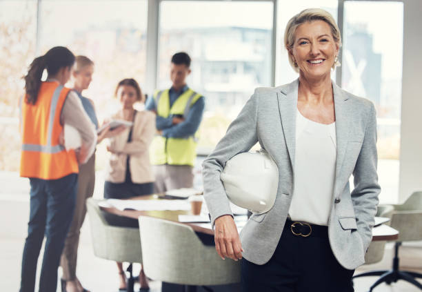 Portrait, construction worker and manager with an engineer woman at work in her architecture office. Industry, design and building with a female architect leader working on a development project