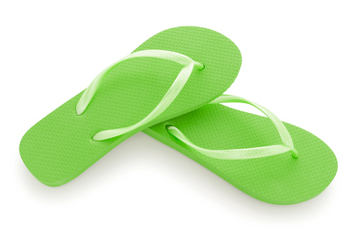 Pair of green thongs sandals isolated on white background