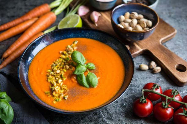 istock Tomato and carrot soup topped with chopped pistachios 1487152006