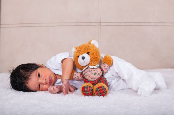 Newborn Baby Boy Sleeping with Toy Bunny