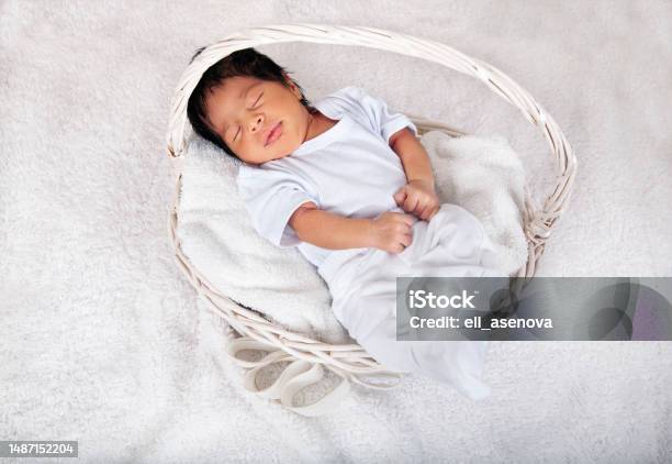Sweet Sleeping Africanamerican Newborn Baby Boy Swaddled In A Blanket And Lying In A Basket Stock Photo - Download Image Now