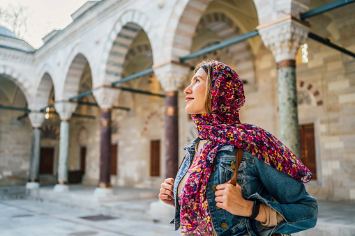 Young veiled woman in the courtyard of the Suleymaniye Mosque in Istanbul, Turkey