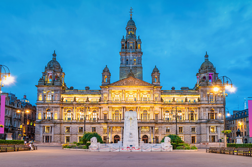 George Square with the City Chambers (city hall building) in downtown Glasgow, Scotland at twilight.